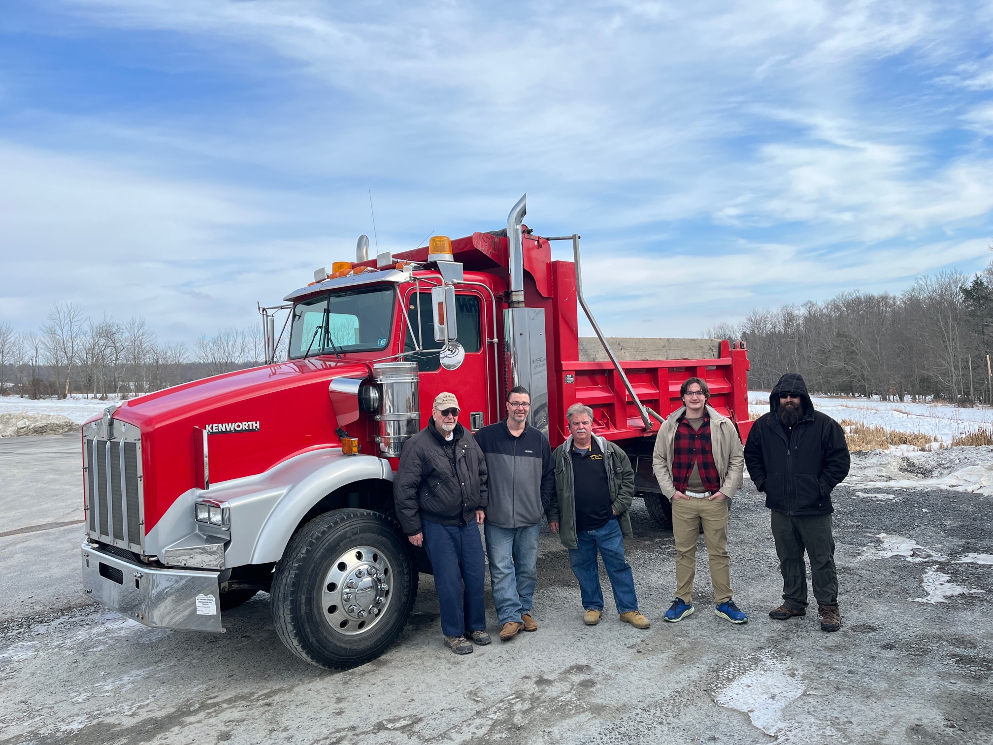 CDL Training Center Instructors and students in front of new dump truck